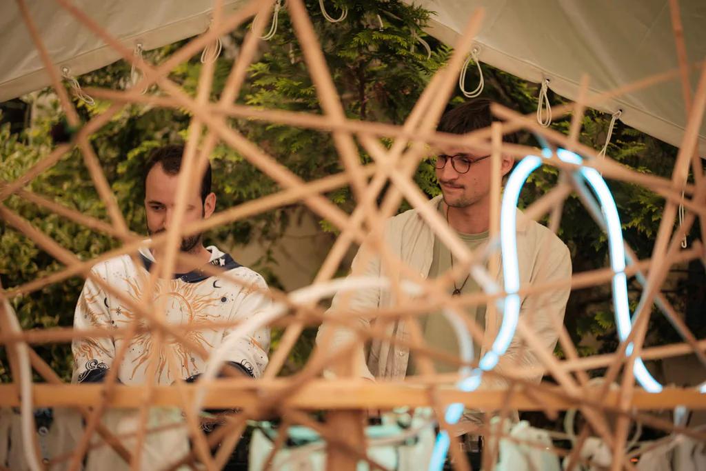AlesK performing behind a geometric stage installation