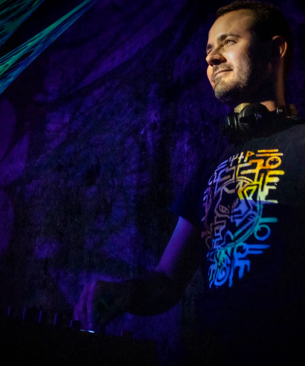 Portrait of AlesK lit by purple and blue stage light