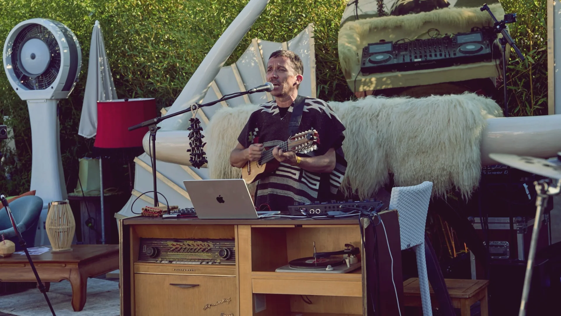 Johan Selva performing with voice, charango and electronic equipment