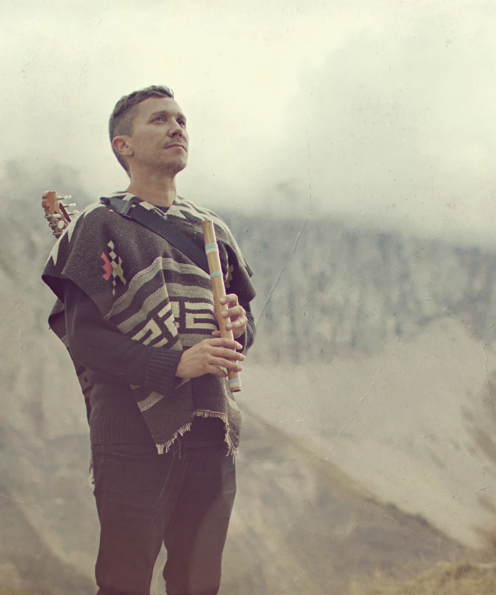 Johan Selva singing and playing charango during a live performance