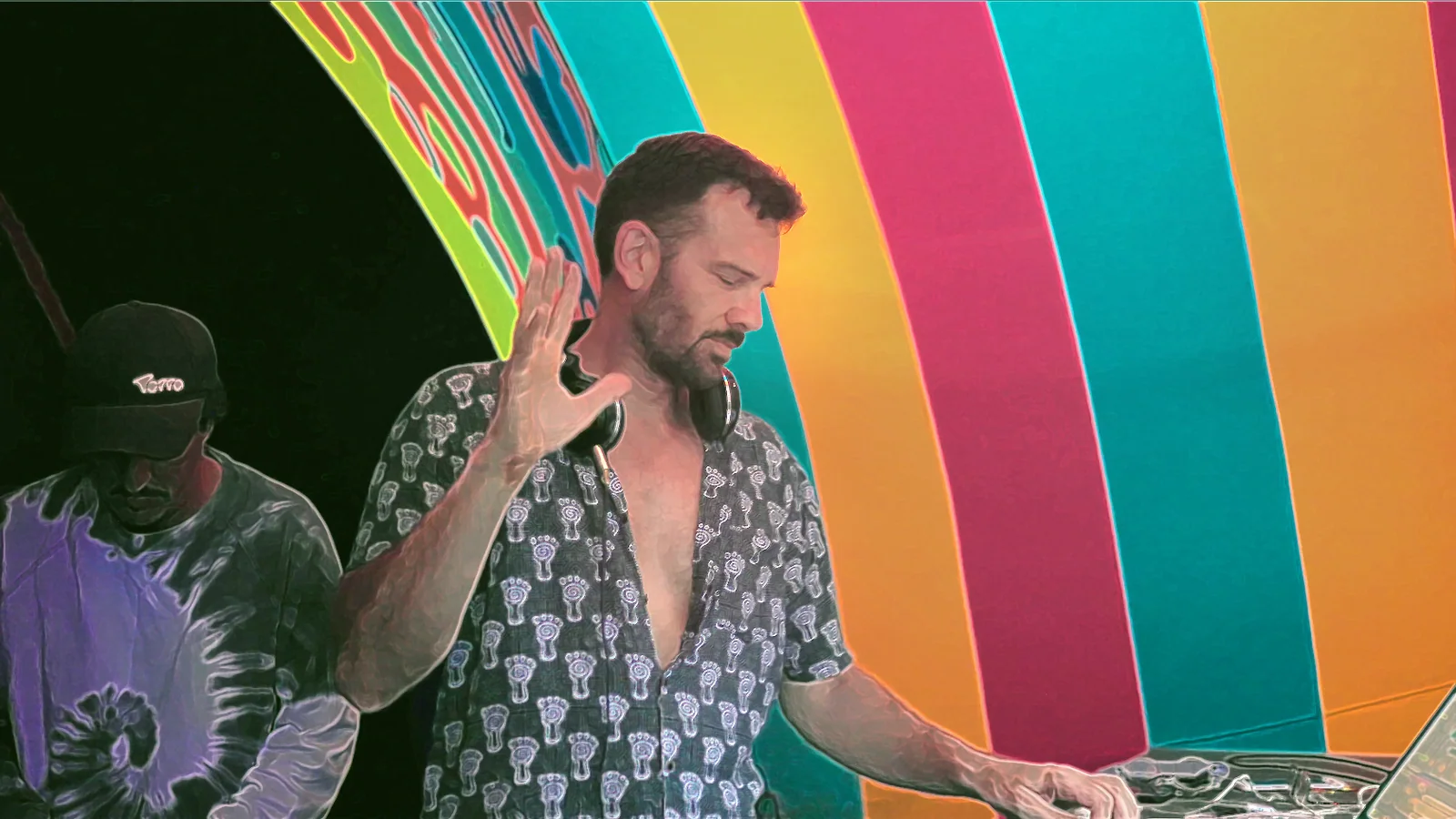 Mandukya performing an electronic set on a colourful festival stage