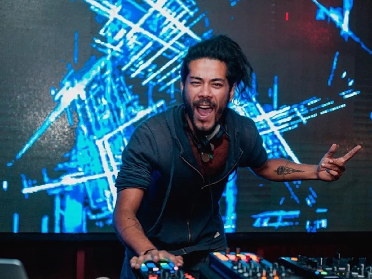 Satrip performing an electronic set on stage