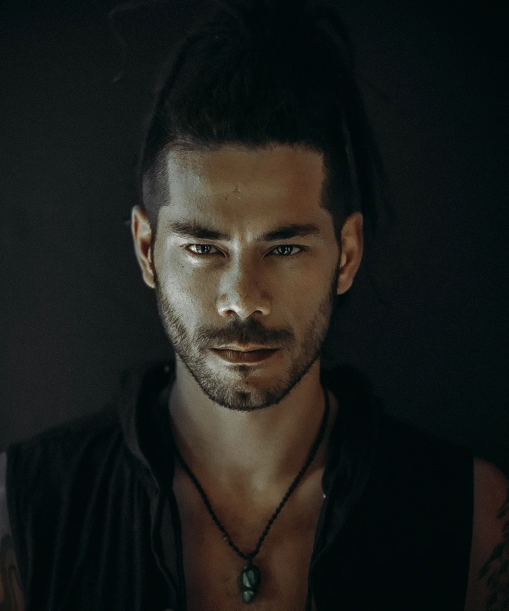 Portrait of Satrip against a dark background