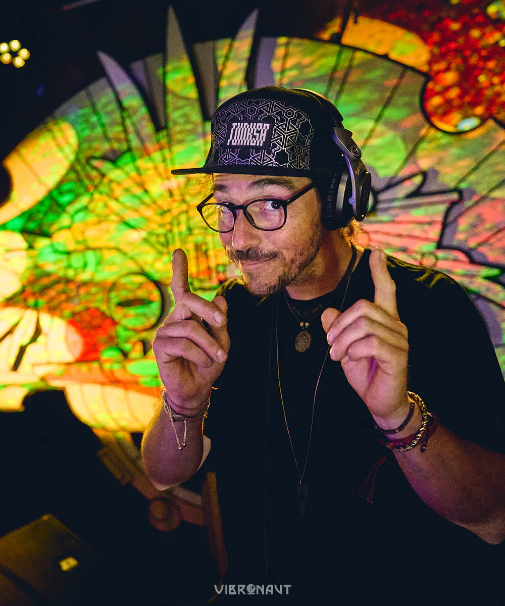 Trippy Fry performing in front of a psychedelic stage installation